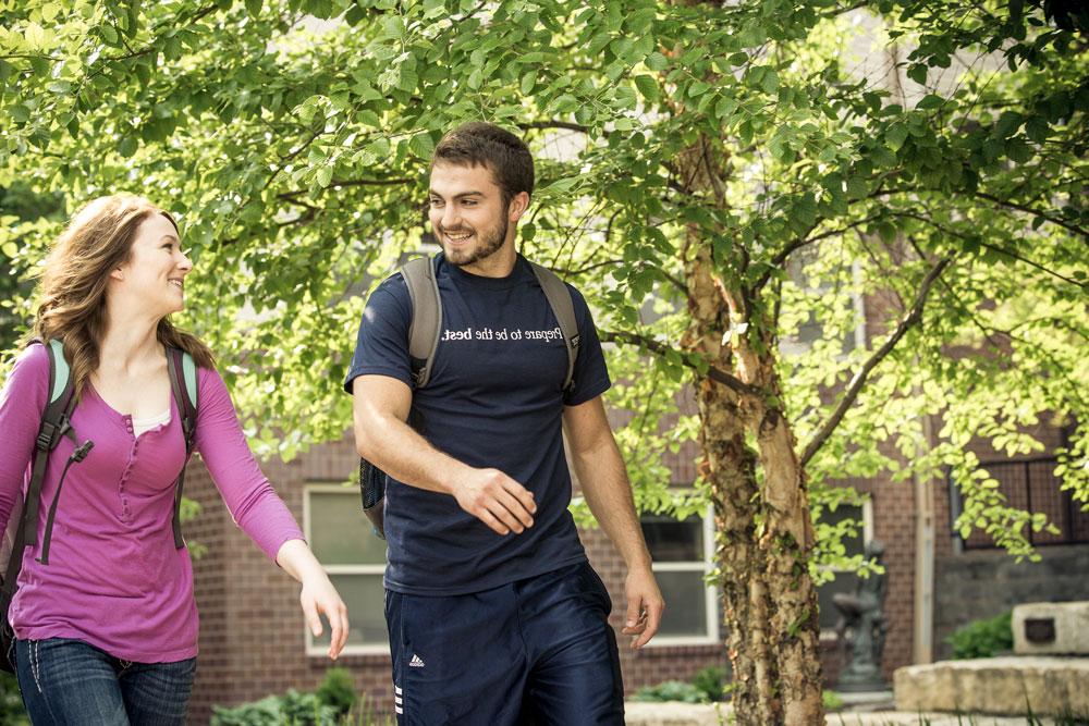 Clarkson College students walking together in the courtyard